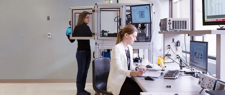 Two women working in a laboratory setting.