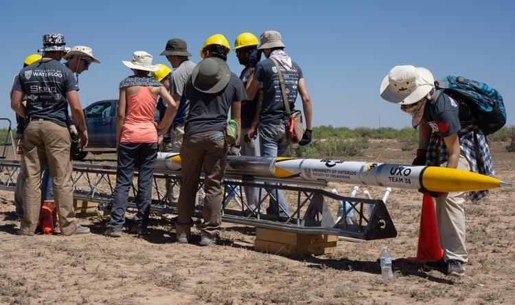 Students work on their rocket at the launch competition.