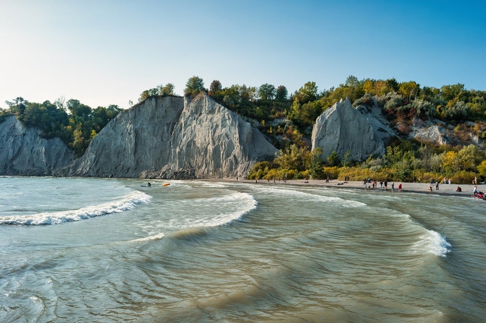 Waves of Lake Ontario lap onto the shore.