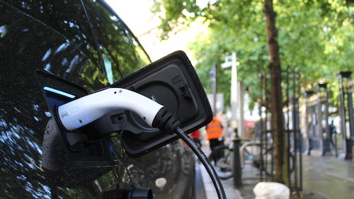 A close-up photo of an electric vehicle being recharged.