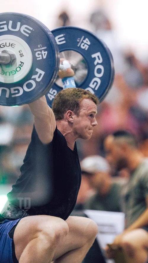 Jack Farlow performs a snatch with barbell weights.