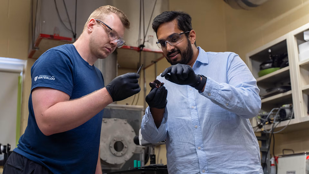 Graduate student Braden Southern and Dr. Vinny Gupta examine remnants of a battery cell.
