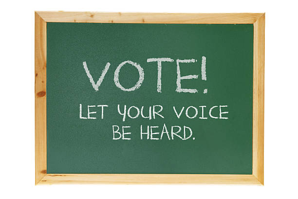 A blackboard slate with the words &quot;VOTE! Let your voice be heard.&quot;