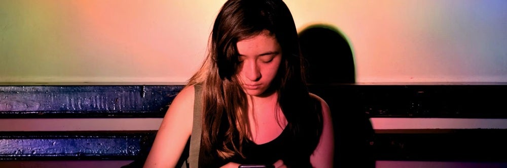 A woman looks at her phone.