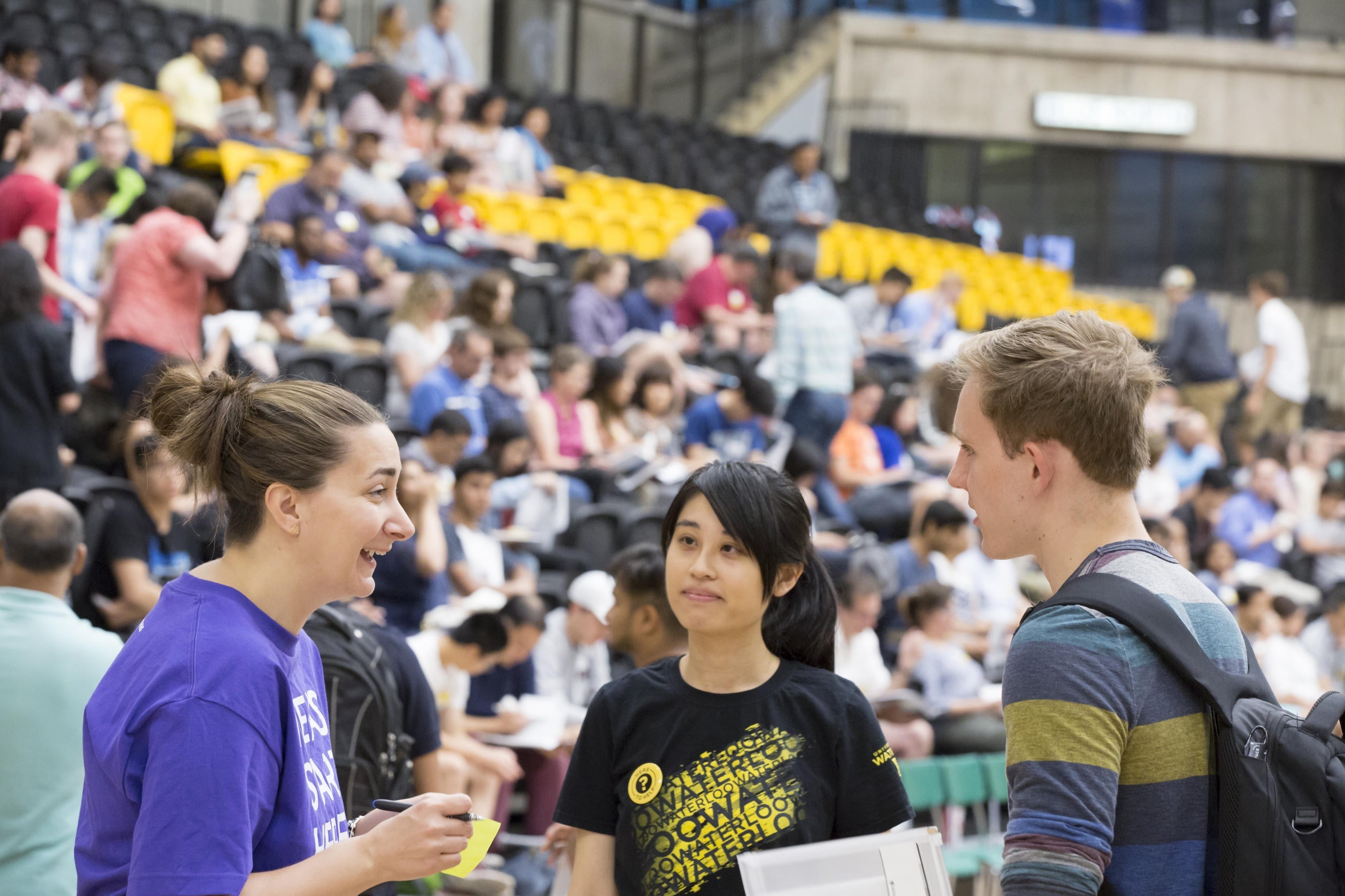 Volunteers speak with a student at a Faculty 101 event.