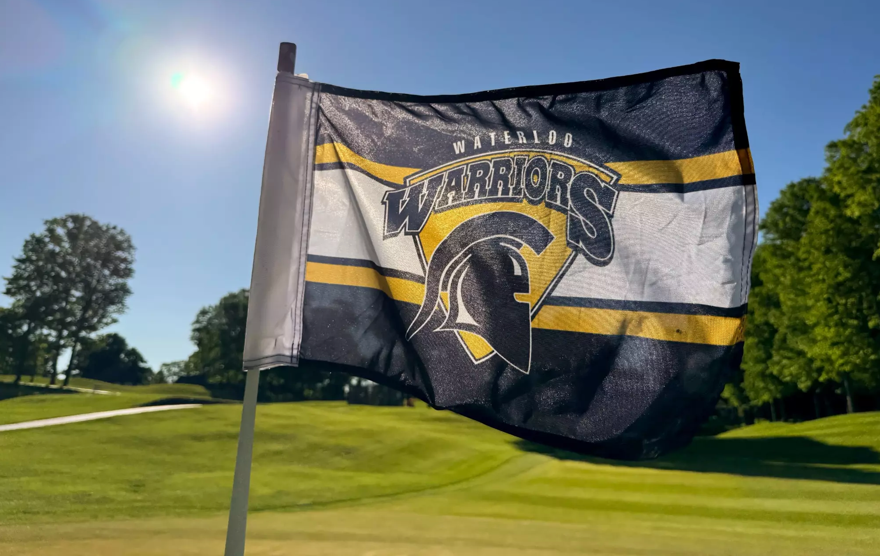 a uwaterloo flag on a golf course