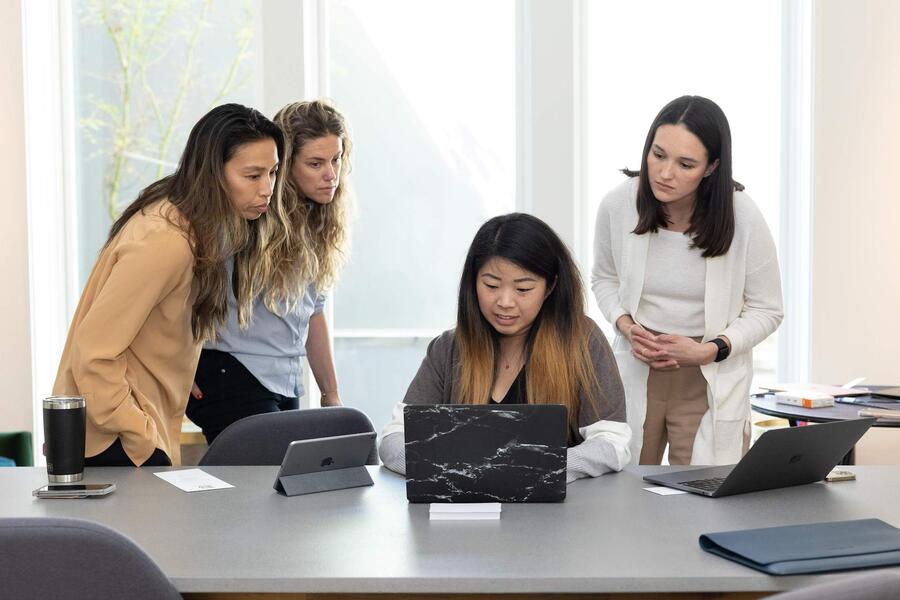 Brigette Lau works with her staff.