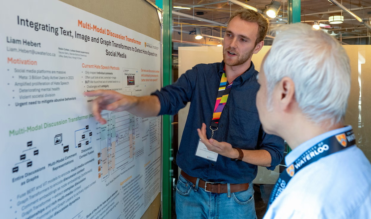 Liam Hebert shares his research on a poster in conversation with Dr. Justin Wan.