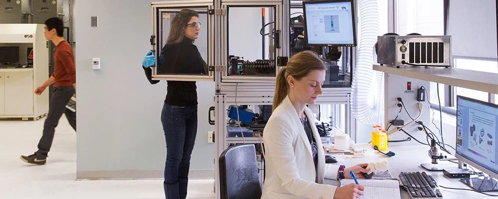 Two women work in a lab.