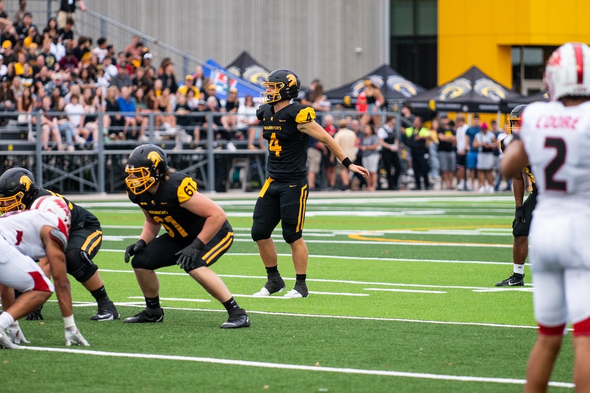 Nick Orr prepares to receive a snap on the football field.