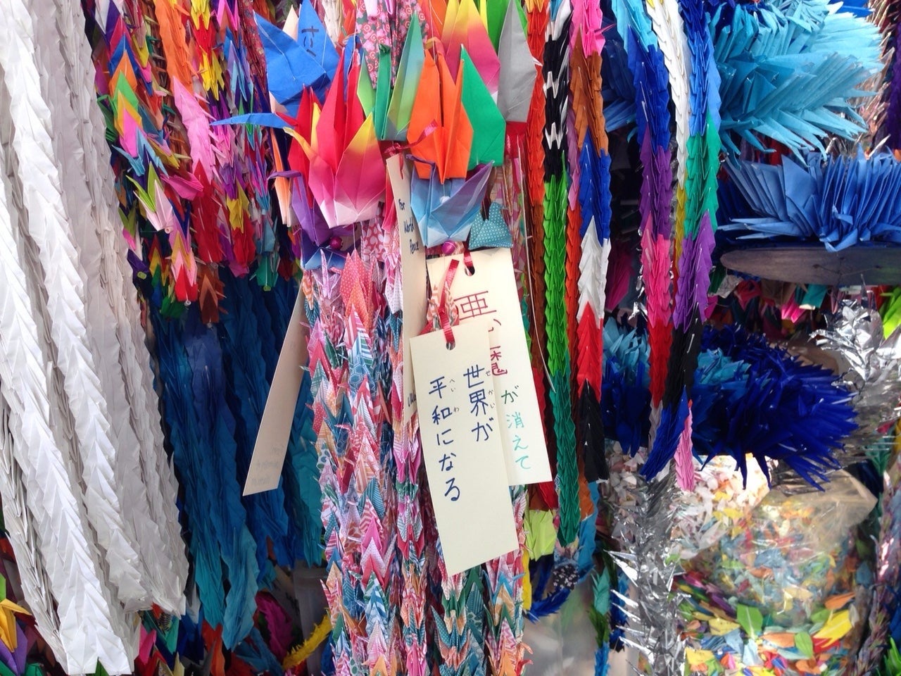 Japanese senbazuru, or paper chains of origami cranes, hanging.