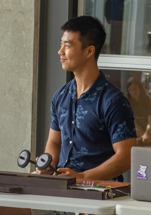 Nicholas Sia performing a piece of music on a redesigned gamelan.