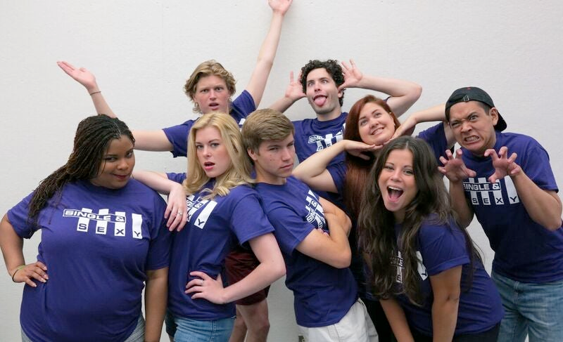 The cast of Single & Sexy in matching purple t-shirts.