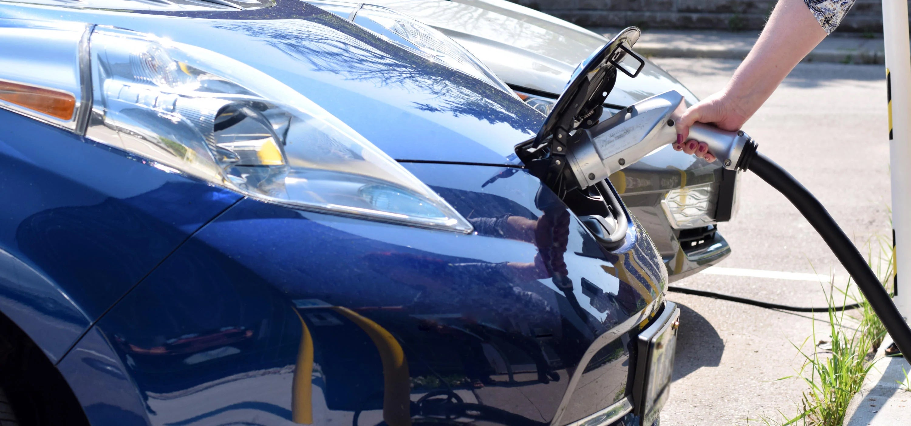 An electric vehicle is plugged in at a charging station near Engineering 6. Photograph by Nina Yan.