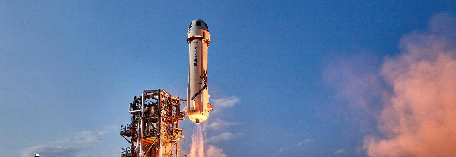 The Blue Origin rocket lifts off from the launch platform.