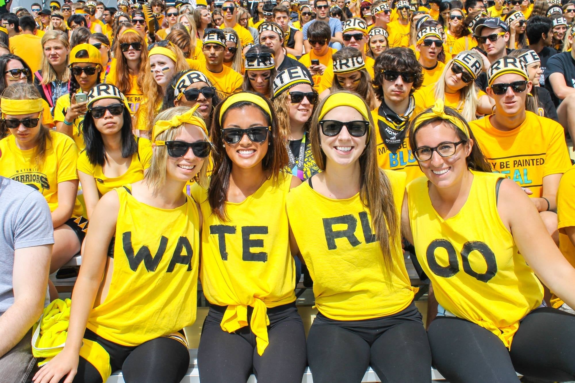 Students in black and yellow in the stands.