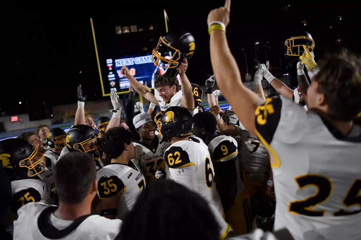 The Warriors celebrate their win on the football field.