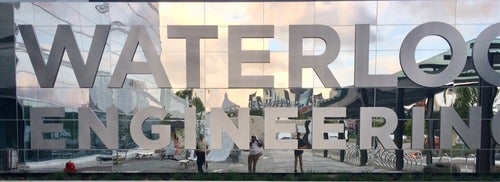The Waterloo Engineering logo on the glassed facade of Engineering 7.