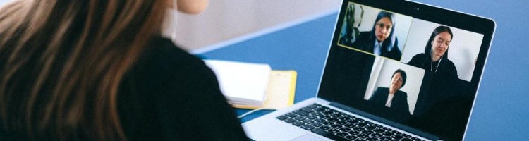 A student participate in an online employer info session via laptop.