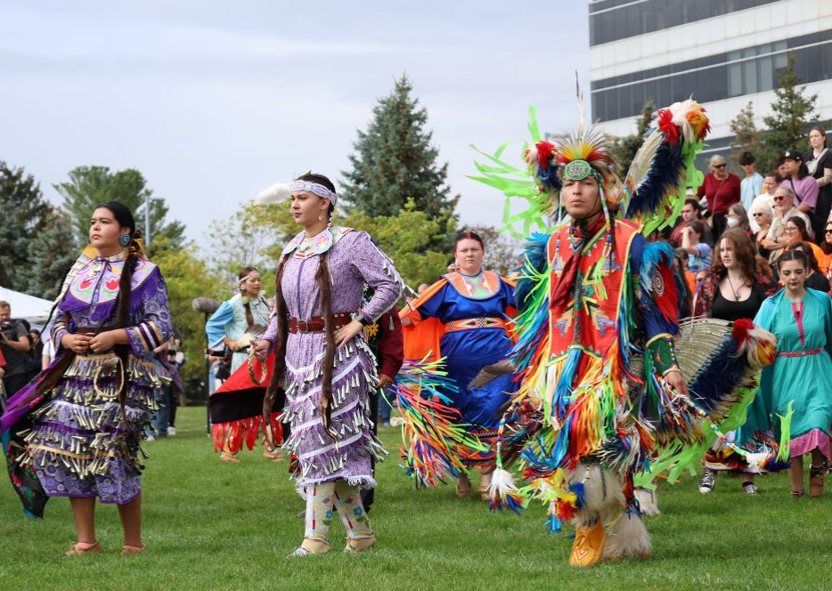 Dancers in traditional Indigenous regalia at the Pow Wow.