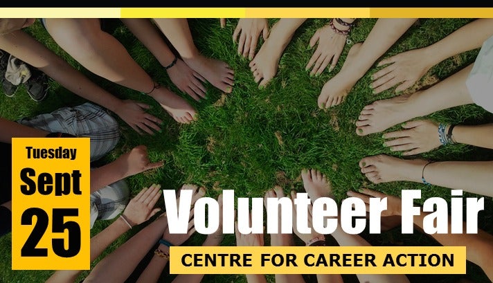 Volunteer Fair image showing people arranging their hands and feet in a circle.