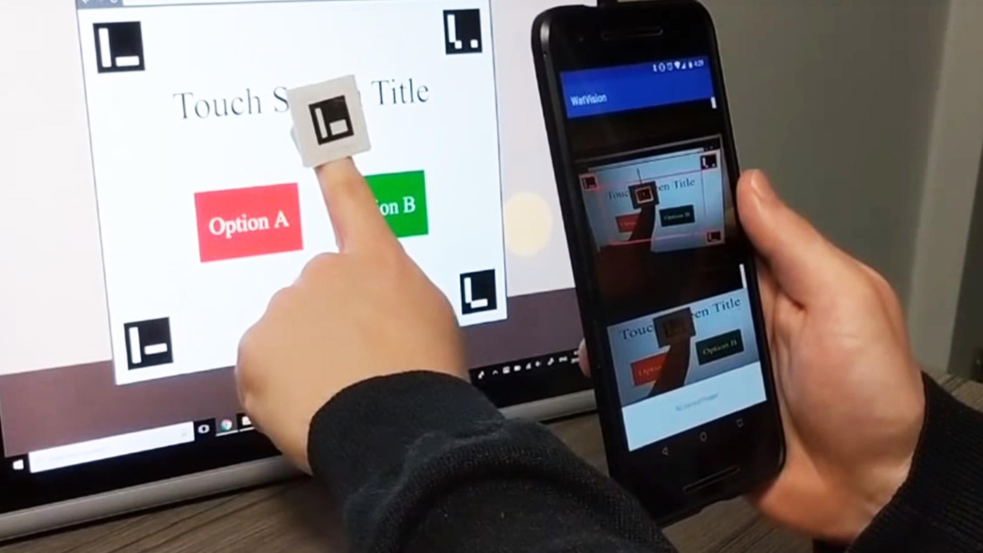 The Watvision device - a ring worn on the index finger - uses a smartphone to decipher text.