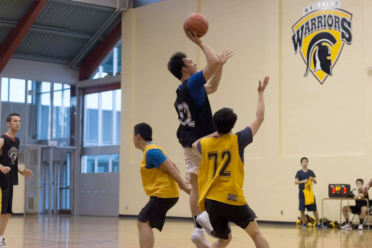 Students play basketball.