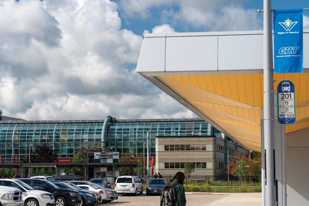 Cars in the parking lot outside of Davis Centre with the transit plaza overhang in view.