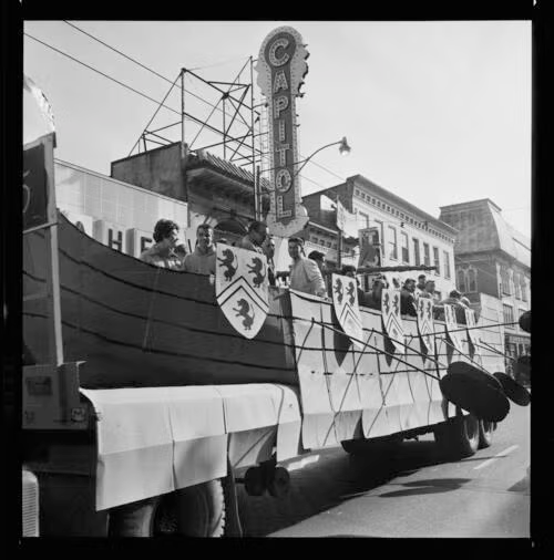 A University of Waterloo parade float in the shape of a galleon rolls past the Capital Theatre on King Street.