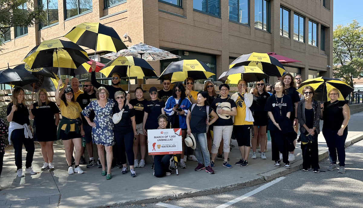 Participants in the march with their black and gold umbrellas.
