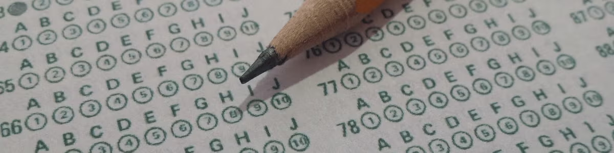 A pencil sits on a multiple choice exam paper.
