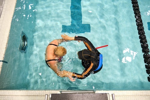 Jacky Beckford-Henriques in the pool with a swimming student.