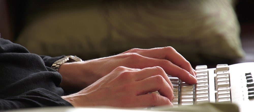 Hands typing at a keyboard