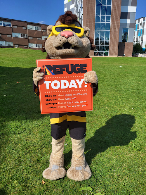 King Warrior holds a Ride for Refuge sign.