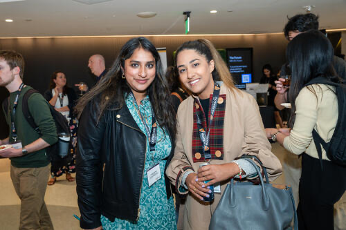 Two women wearing lanyards.