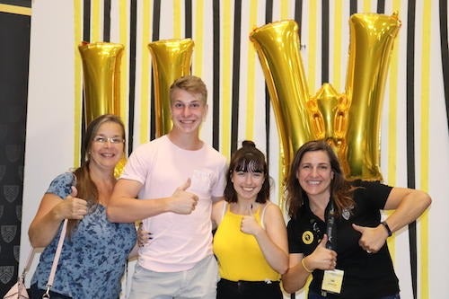 Orientation volunteer Lisa Brackenridge with a first-year student and his family at Family Send-Off.