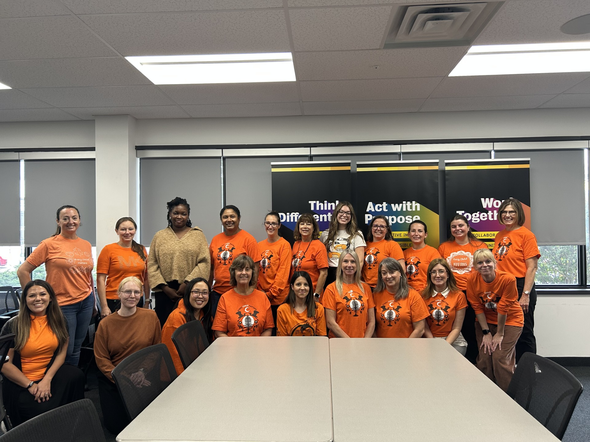 HR staff pose in orange shirts for National Day for Truth and Reconciliation