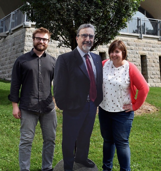 Staff members pose with a cardboard cutout of Feridun Hamdullahpur.