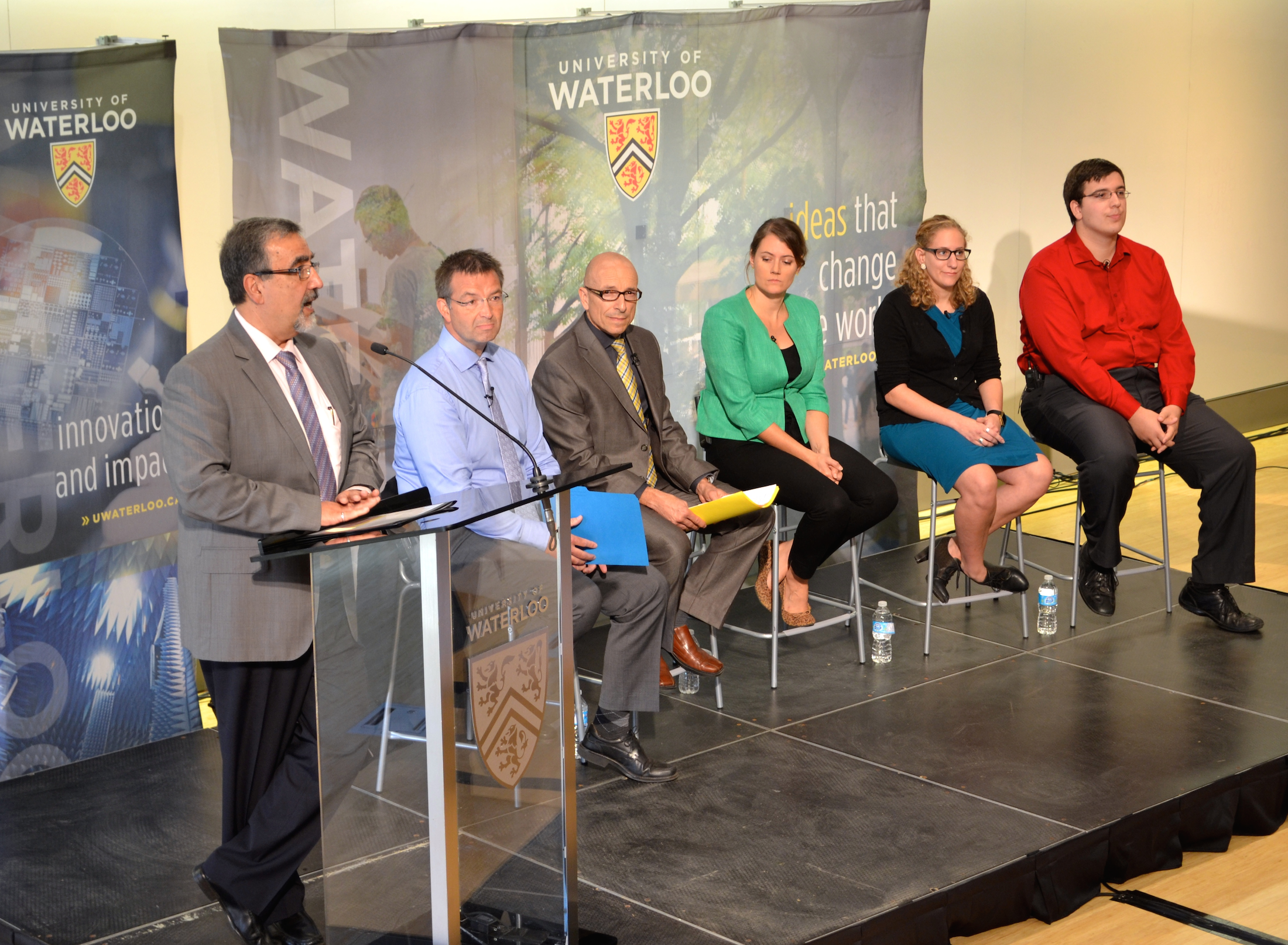 Feridun Hamdullahpur speaks at the town hall as the panelists look on.