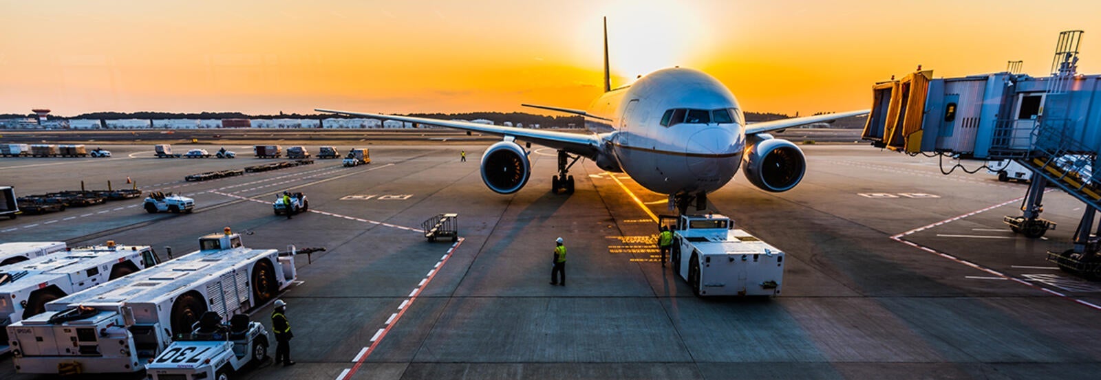 A passenger jet on the tarmac at an airport.