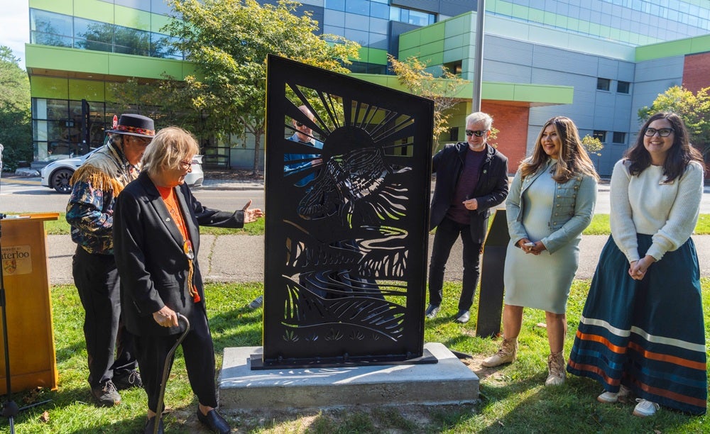 Elder Myeengun Henry, Carolyn King, Neil Carnegie, John Lewis, Laurie Froman and Amanda St. Marie unveil the Moccasin Identifier Treaty Marker