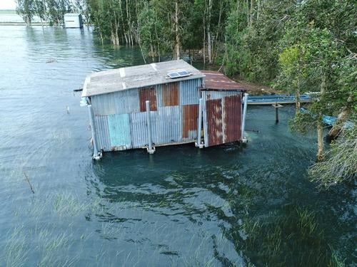 A small house designed to withstand flooding is shown on the water
