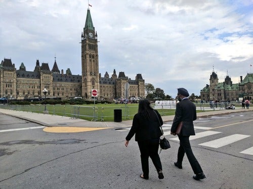 Munaza Saleem and Minister Harjit Sajjan walk towards Parliament Hill.