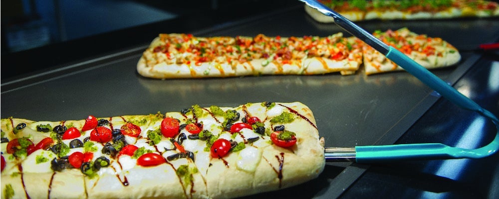 Flatbread cooking on a grill.