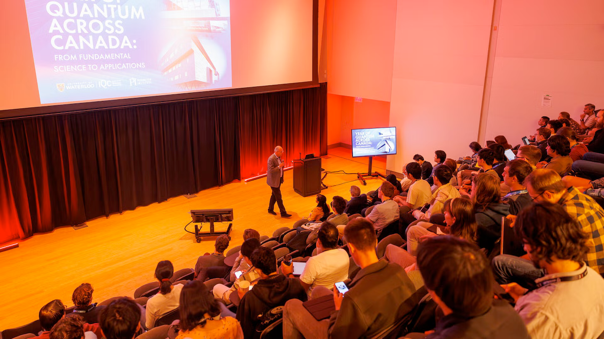 A speaker delivers a presentation in the Quantum-Nano Centre's lecture hall.