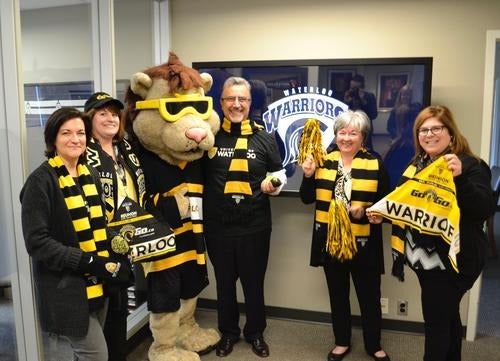 Feridun Hamdullahpur and his office staff wear Black and Gold gear.
