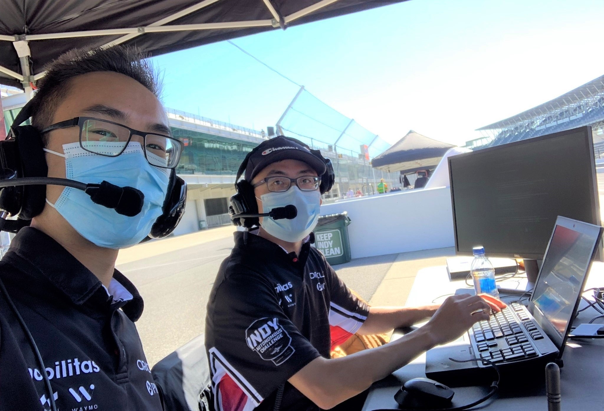 Brian Mao, left, and Ben Zhang work trackside during testing at the Indianapolis Motor Speedway.