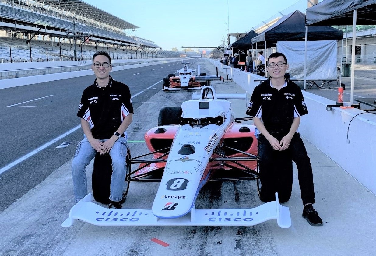 Mao (left) and Ben Zhang with their million-dollar Dallara AV-21 car.