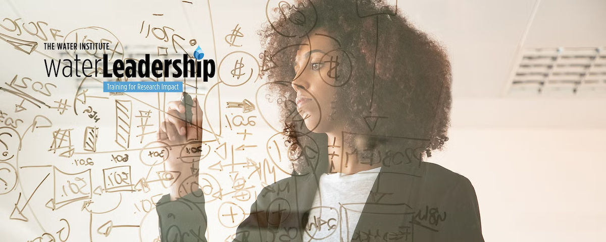 A woman writes on a transparent surface.