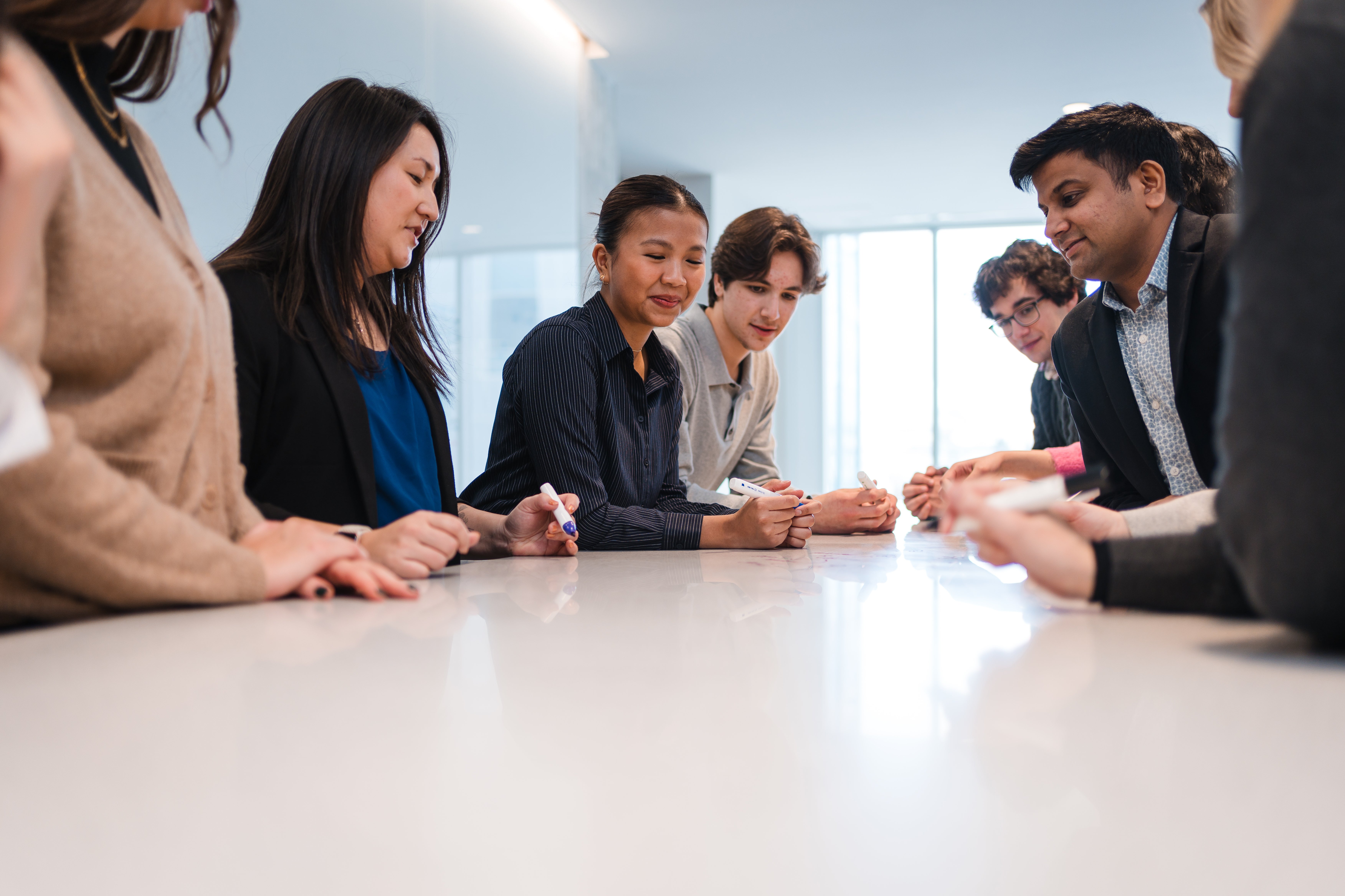 Group of people collaborating around a desk
